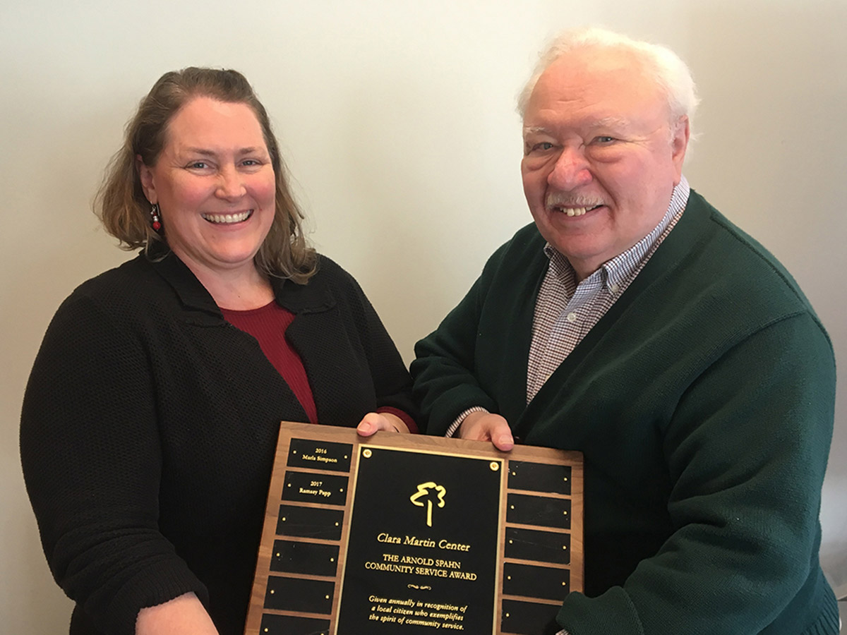 Arny Spahn presenting the 2017 Arny Spahn Community Service Award to Ramsey Papp of Capstone Community Action