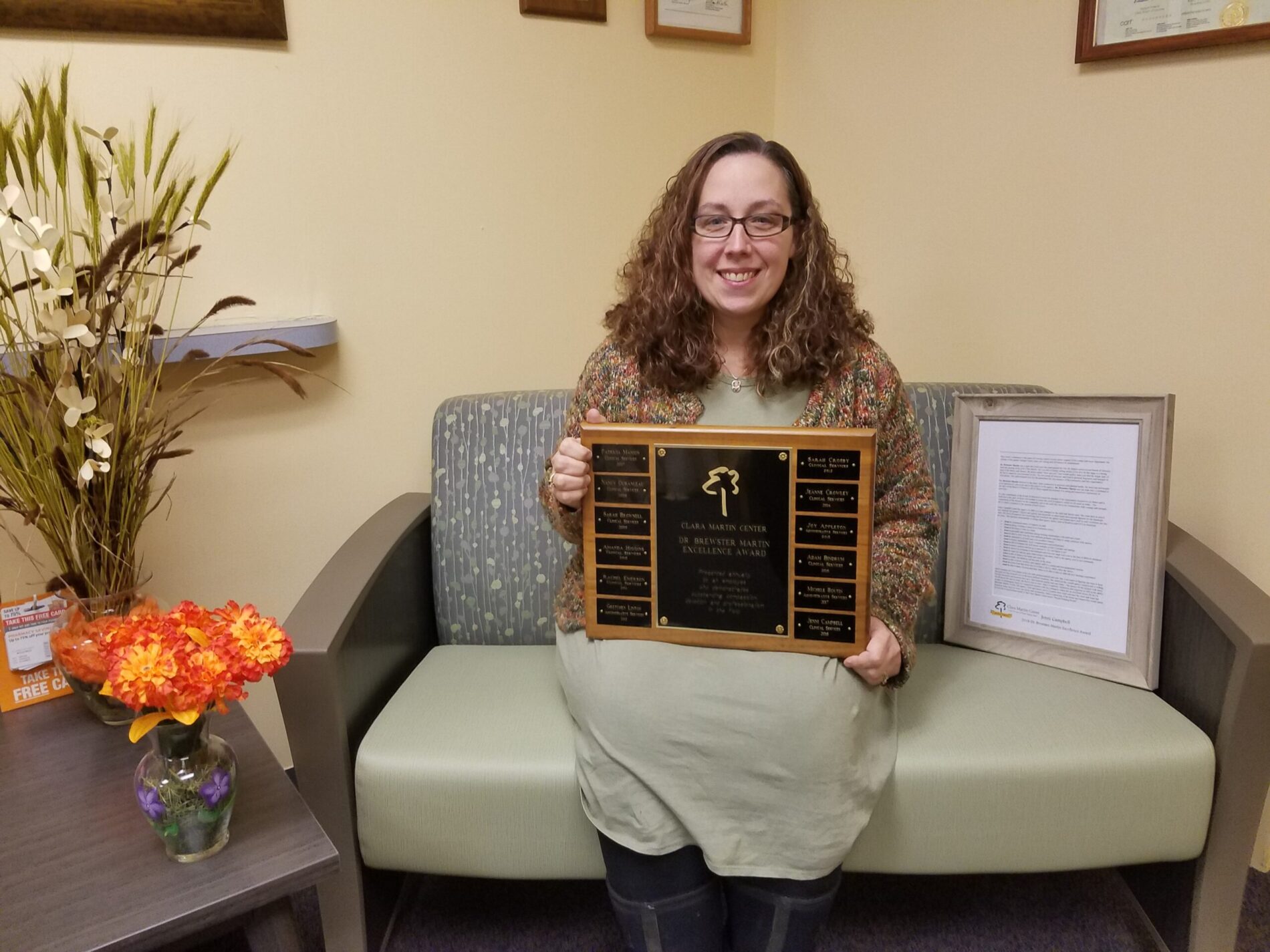 Jenni Campbell holding the 2018 Dr. Brewster Martin Award